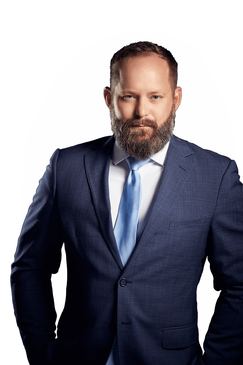 Photo of J.R. Kuhlmann in a dark blue suit, white shirt, and metallic blue tie